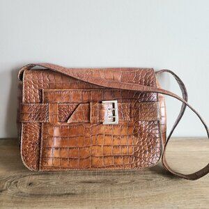 Browns Couture Made in Italy brown leather messenger bag with decorative buckle.